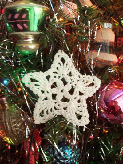 Photo of Christmas tree ornaments with a white star in the center